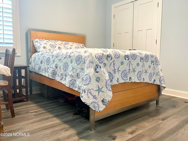 bedroom with a closet and hardwood / wood-style flooring