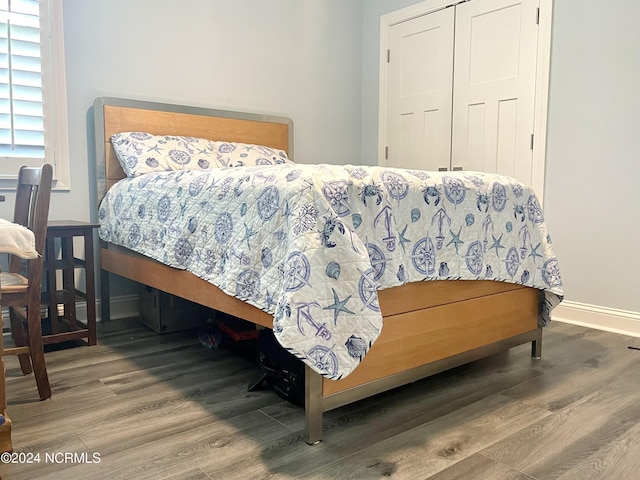 113 Evergreen Ln, Pine Knoll Shores, NC 28512 - bedroom with wood finished floors, baseboards, and a closet