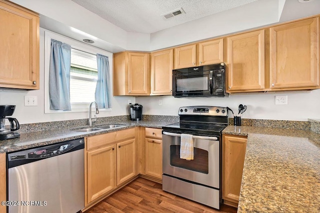 113 Scallop Ln, Carolina Beach, NC 28428 - kitchen with appliances with stainless steel finishes, light brown cabinets, dark wood-style floors, and a textured ceiling
