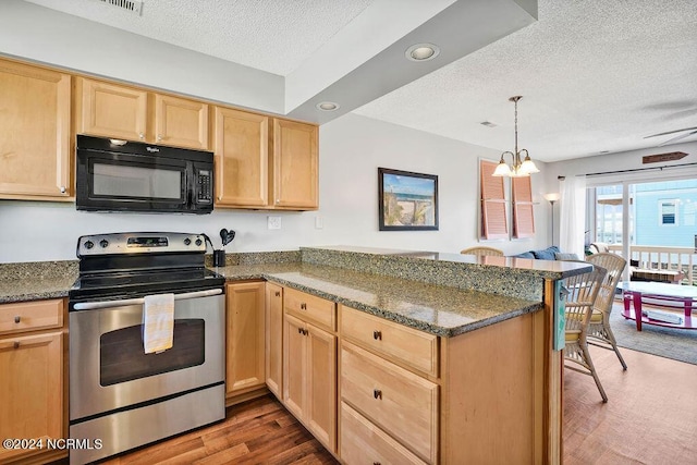 113 Scallop Ln, Carolina Beach, NC 28428 - kitchen with black microwave, stainless steel electric range oven, a textured ceiling, a peninsula, and light brown cabinets