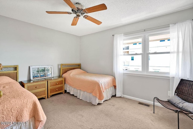 113 Scallop Ln, Carolina Beach, NC 28428 - bedroom featuring light carpet, ceiling fan, and a textured ceiling
