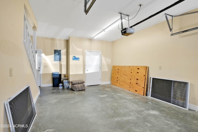113 Scallop Ln, Carolina Beach, NC 28428 - garage featuring a garage door opener and baseboards