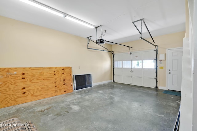113 Scallop Ln, Carolina Beach, NC 28428 - garage featuring a garage door opener and baseboards
