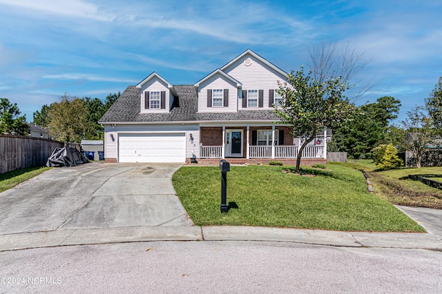 view of front of property featuring a front yard, a porch, and a garage