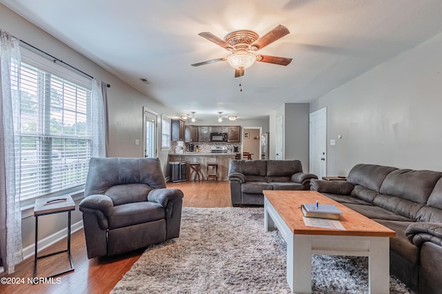 living room with ceiling fan and light wood-type flooring