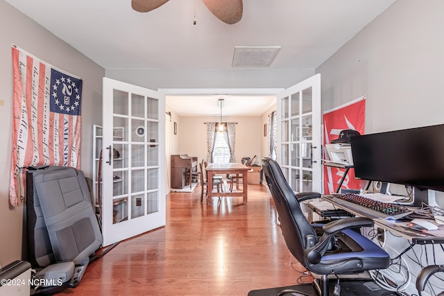 home office with wood-type flooring, ceiling fan, and french doors