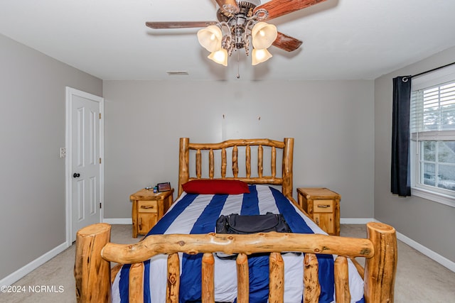 bedroom featuring light carpet and ceiling fan