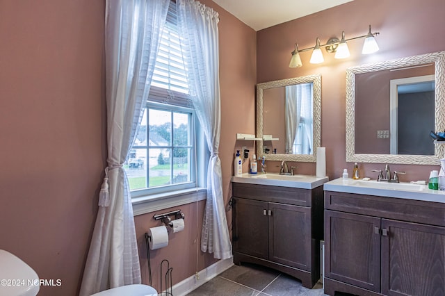 bathroom with tile patterned flooring, vanity, and toilet