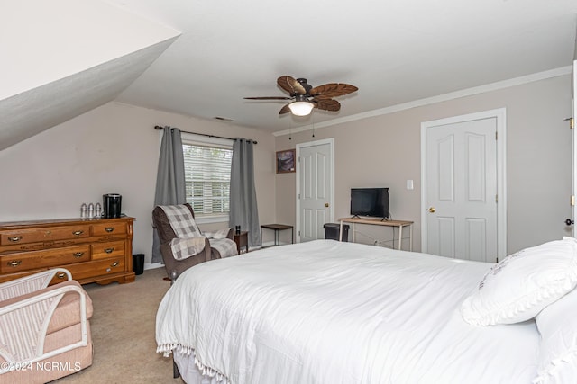 bedroom featuring crown molding, vaulted ceiling, light carpet, and ceiling fan