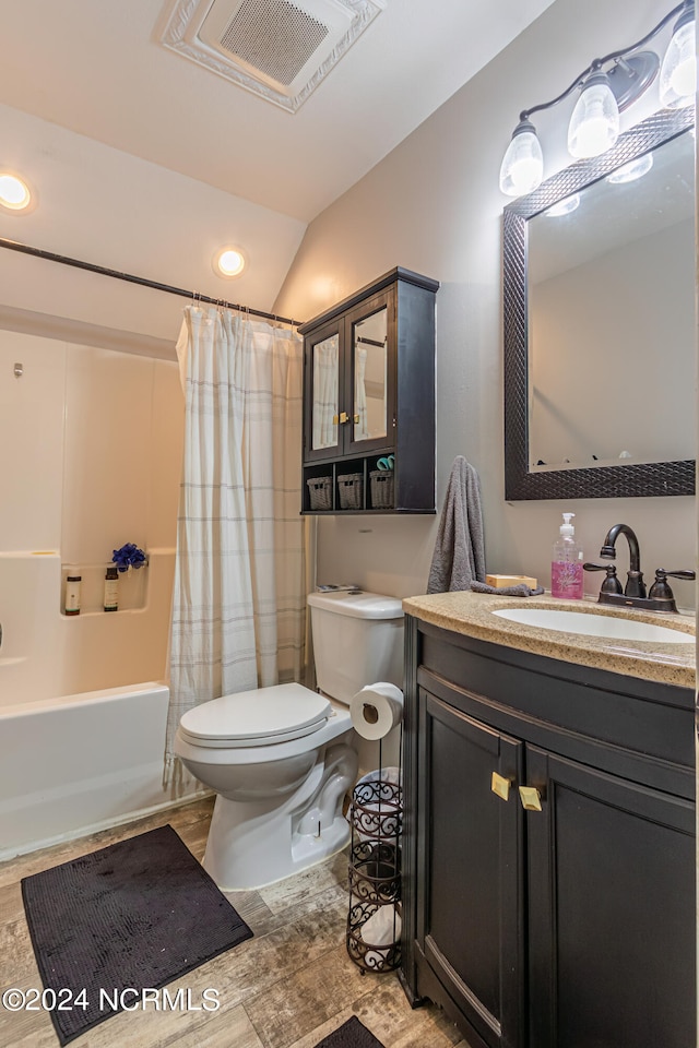 full bathroom featuring vanity, lofted ceiling, wood-type flooring, shower / bath combo with shower curtain, and toilet