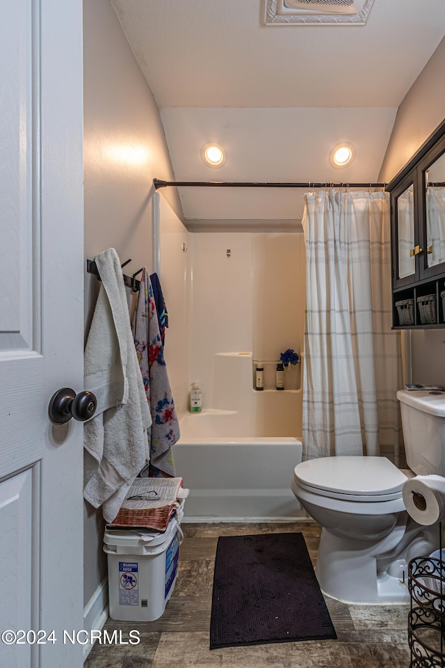 bathroom featuring shower / bath combo, vaulted ceiling, toilet, and hardwood / wood-style flooring