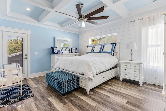 bedroom with beam ceiling, coffered ceiling, baseboards, and wood finished floors