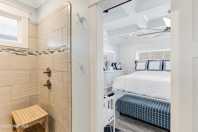 ensuite bathroom with coffered ceiling, a ceiling fan, beam ceiling, tiled shower, and ensuite bathroom