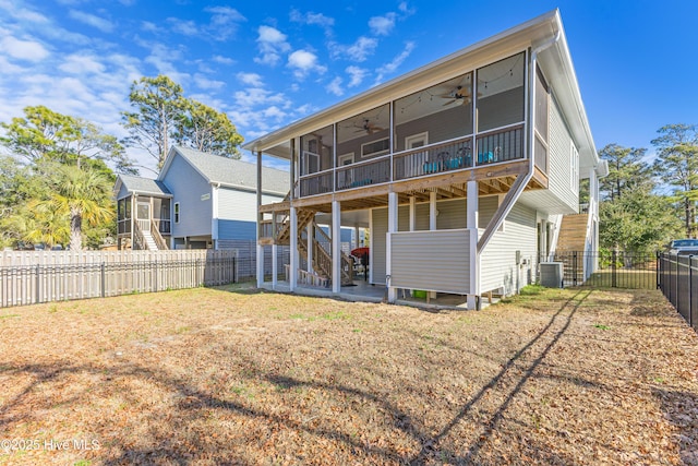 rear view of property with a fenced backyard, cooling unit, a sunroom, stairs, and ceiling fan