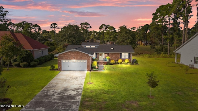 view of front of house with a yard and a garage