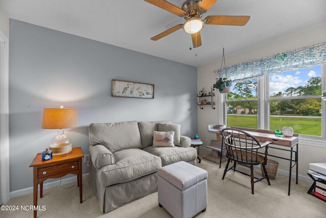 carpeted living room with ceiling fan