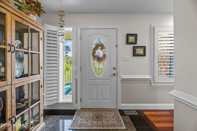 entrance foyer featuring a textured ceiling and dark hardwood / wood-style flooring