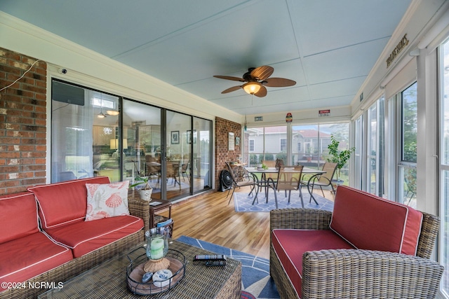 sunroom / solarium featuring ceiling fan