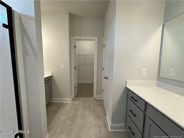 bathroom with tile patterned flooring and vanity