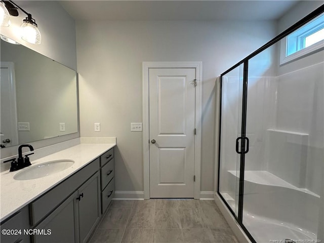 bathroom featuring vanity and a shower with shower door