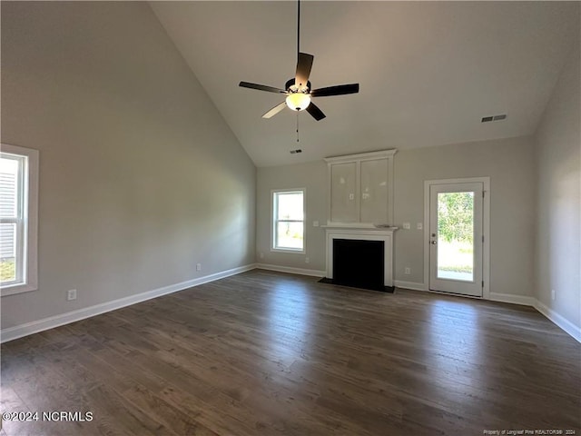 unfurnished living room with dark hardwood / wood-style floors, ceiling fan, and high vaulted ceiling