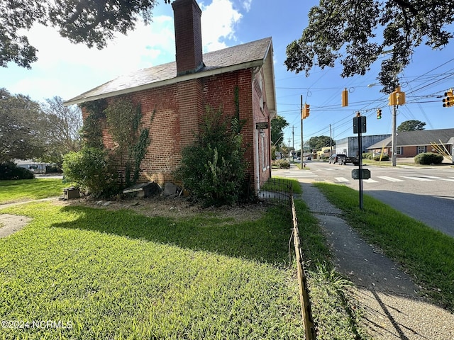 view of side of home with a lawn