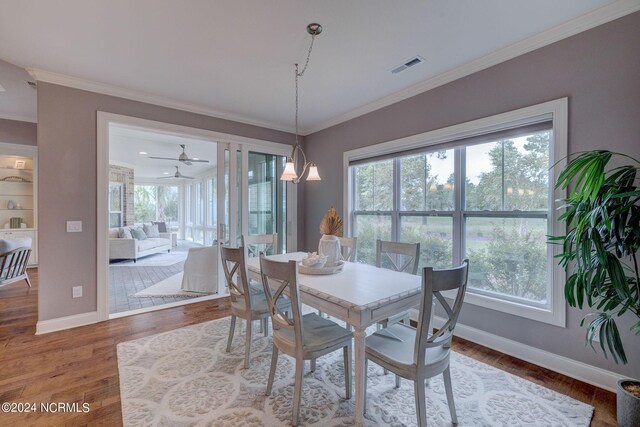 8711 Compass Pointe W Wynd Wynd NE, Leland, NC 28451 - dining area featuring crown molding, a wealth of natural light, and visible vents
