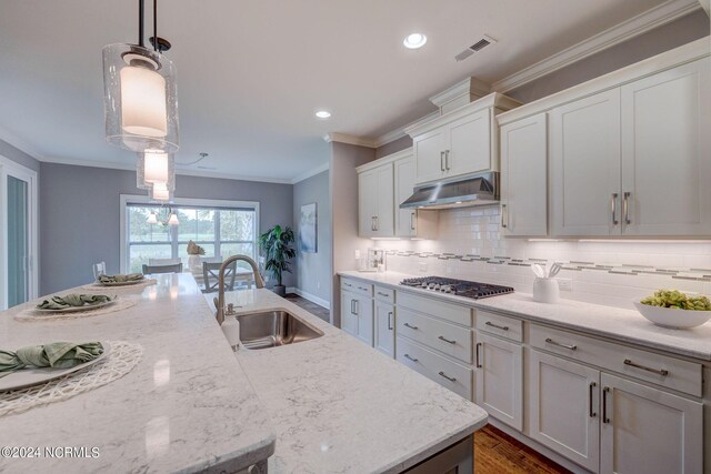 8711 Compass Pointe W Wynd Wynd NE, Leland, NC 28451 - kitchen with visible vents, stainless steel gas cooktop, under cabinet range hood, tasteful backsplash, and a sink