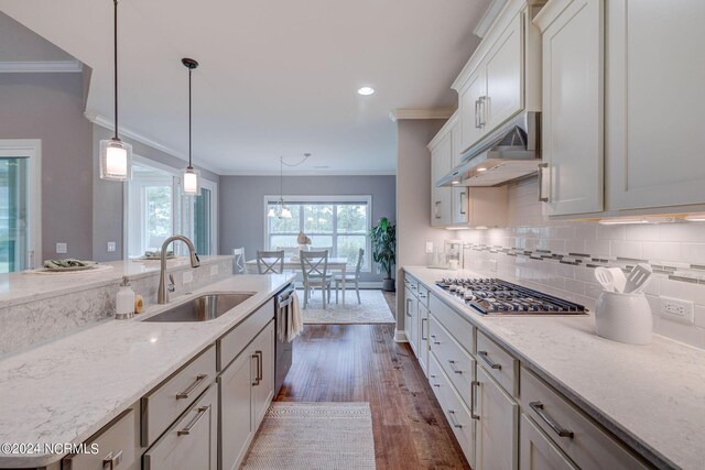 8711 Compass Pointe W Wynd Wynd NE, Leland, NC 28451 - kitchen featuring crown molding, appliances with stainless steel finishes, under cabinet range hood, and a sink