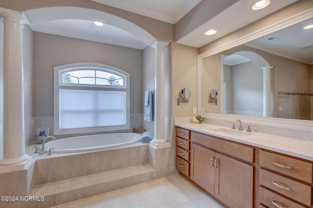 8711 Compass Pointe W Wynd Wynd NE, Leland, NC 28451 - bathroom featuring tile patterned flooring, vanity, decorative columns, ornamental molding, and a garden tub