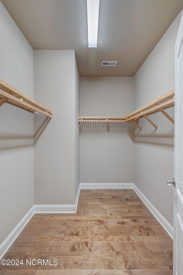 8711 Compass Pointe W Wynd Wynd NE, Leland, NC 28451 - walk in closet with wood finished floors and visible vents