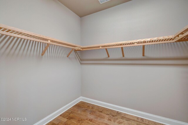 8711 Compass Pointe W Wynd Wynd NE, Leland, NC 28451 - walk in closet featuring visible vents, lofted ceiling, and light wood-type flooring