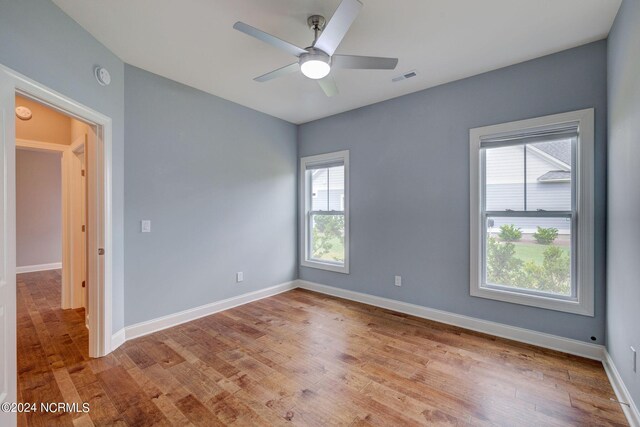 8711 Compass Pointe W Wynd Wynd NE, Leland, NC 28451 - unfurnished room with baseboards, a ceiling fan, wood finished floors, and visible vents