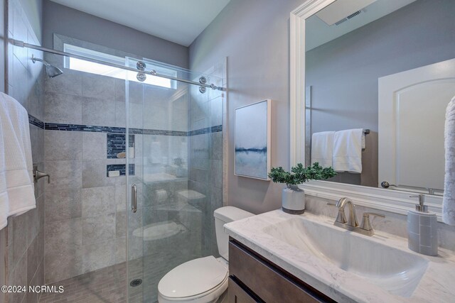 8711 Compass Pointe W Wynd Wynd NE, Leland, NC 28451 - bathroom with vanity, a stall shower, visible vents, and toilet