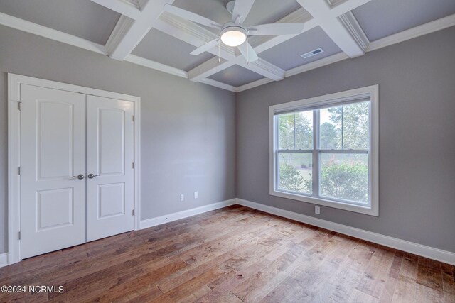 8711 Compass Pointe W Wynd Wynd NE, Leland, NC 28451 - unfurnished bedroom featuring baseboards, coffered ceiling, wood finished floors, and visible vents