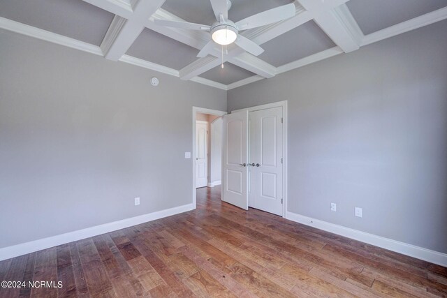 8711 Compass Pointe W Wynd Wynd NE, Leland, NC 28451 - unfurnished bedroom featuring ceiling fan, beam ceiling, baseboards, wood finished floors, and coffered ceiling