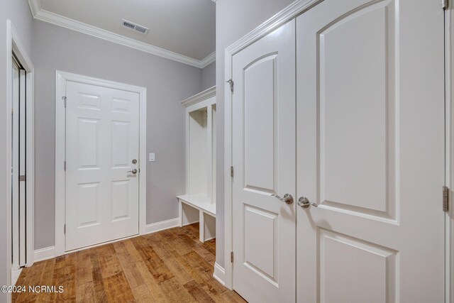 8711 Compass Pointe W Wynd Wynd NE, Leland, NC 28451 - mudroom with crown molding, baseboards, light wood-type flooring, and visible vents
