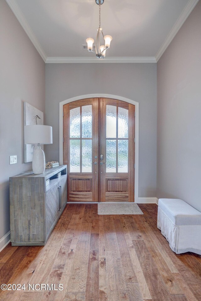 8711 Compass Pointe W Wynd Wynd NE, Leland, NC 28451 - doorway to outside with french doors, crown molding, wood finished floors, and an inviting chandelier