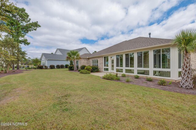8711 Compass Pointe W Wynd Wynd NE, Leland, NC 28451 - back of house featuring a lawn and a shingled roof