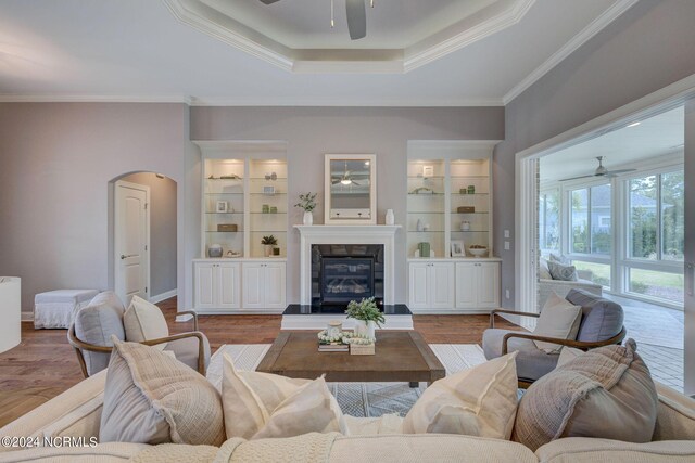 8711 Compass Pointe W Wynd Wynd NE, Leland, NC 28451 - living room with crown molding, a ceiling fan, a raised ceiling, and arched walkways