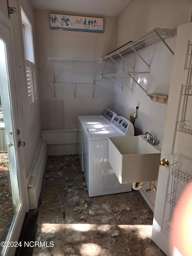 clothes washing area featuring sink and washing machine and dryer