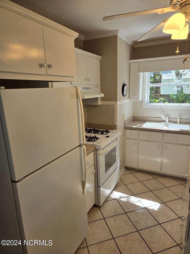 kitchen with tasteful backsplash, sink, white cabinetry, white appliances, and light tile patterned floors