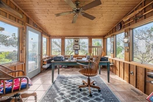 sunroom / solarium with ceiling fan, wooden ceiling, and vaulted ceiling