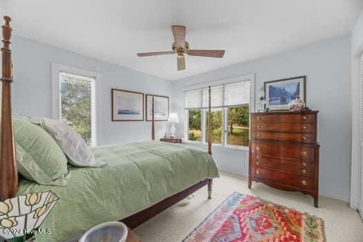 bedroom featuring ceiling fan and light colored carpet