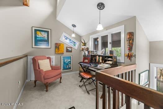 sitting room with light colored carpet and vaulted ceiling