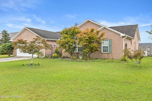 view of front facade with a front yard and a garage