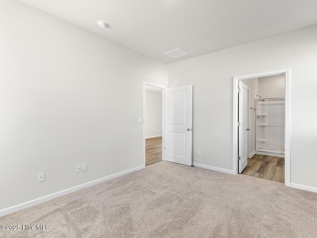 unfurnished bedroom with baseboards and light colored carpet