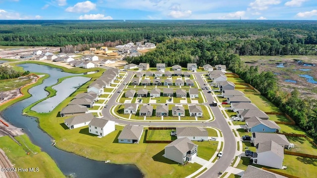 aerial view featuring a water view, a residential view, and a view of trees