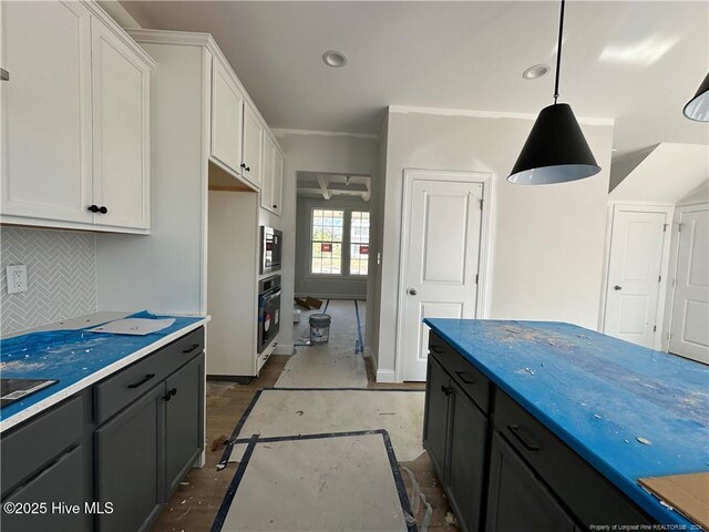 kitchen featuring gray cabinetry, white cabinetry, stainless steel appliances, decorative light fixtures, and decorative backsplash