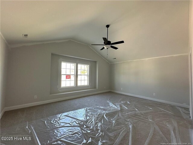 empty room featuring ceiling fan and vaulted ceiling